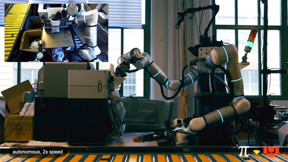 A white industrial robotic arm with multiple joints and an orange-tipped gripper operating at a workstation next to a yellow conveyor belt. An inset video in the top-left corner shows a top-down view of the robot's workspace and sorting bins.