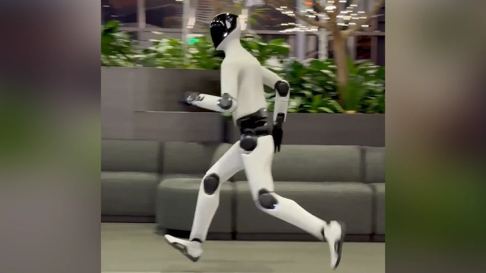 The Figure 03 humanoid robot running indoors, captured mid-stride.
