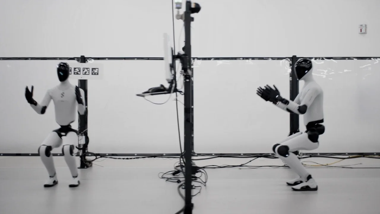 A close-up view of the head and neck assembly of a Figure 03 robot as a technician in black gloves carefully aligns and attaches the sleek black head to the chassis.