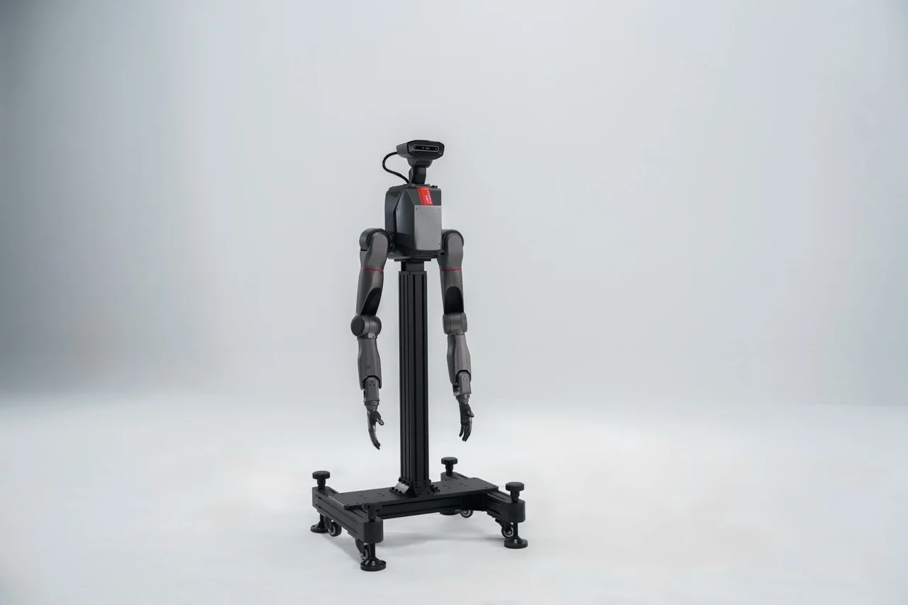 The TRON 2 upper body module mounted on a black vertical stand. It features a head with RGBD cameras and two robotic arms with dexterous hands.