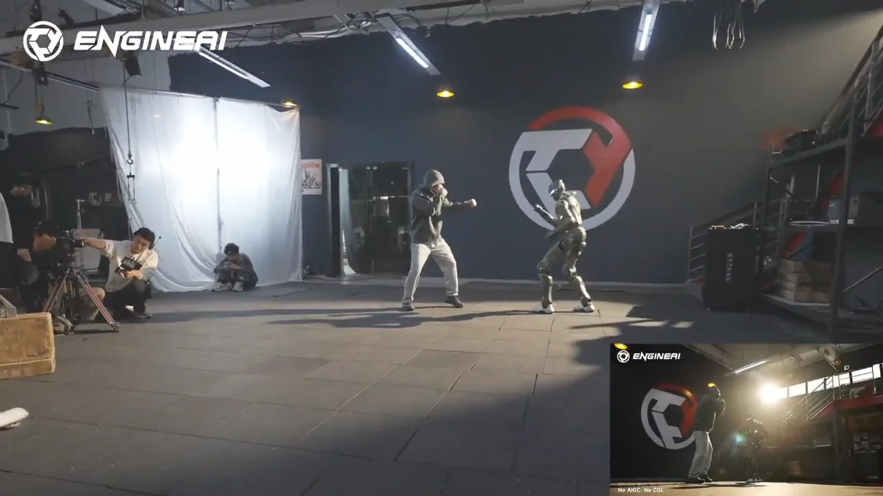 A dramatic mid-air action shot showing a human martial artist in a hoodie and the EngineAI T800 robot performing synchronized flying side kicks.