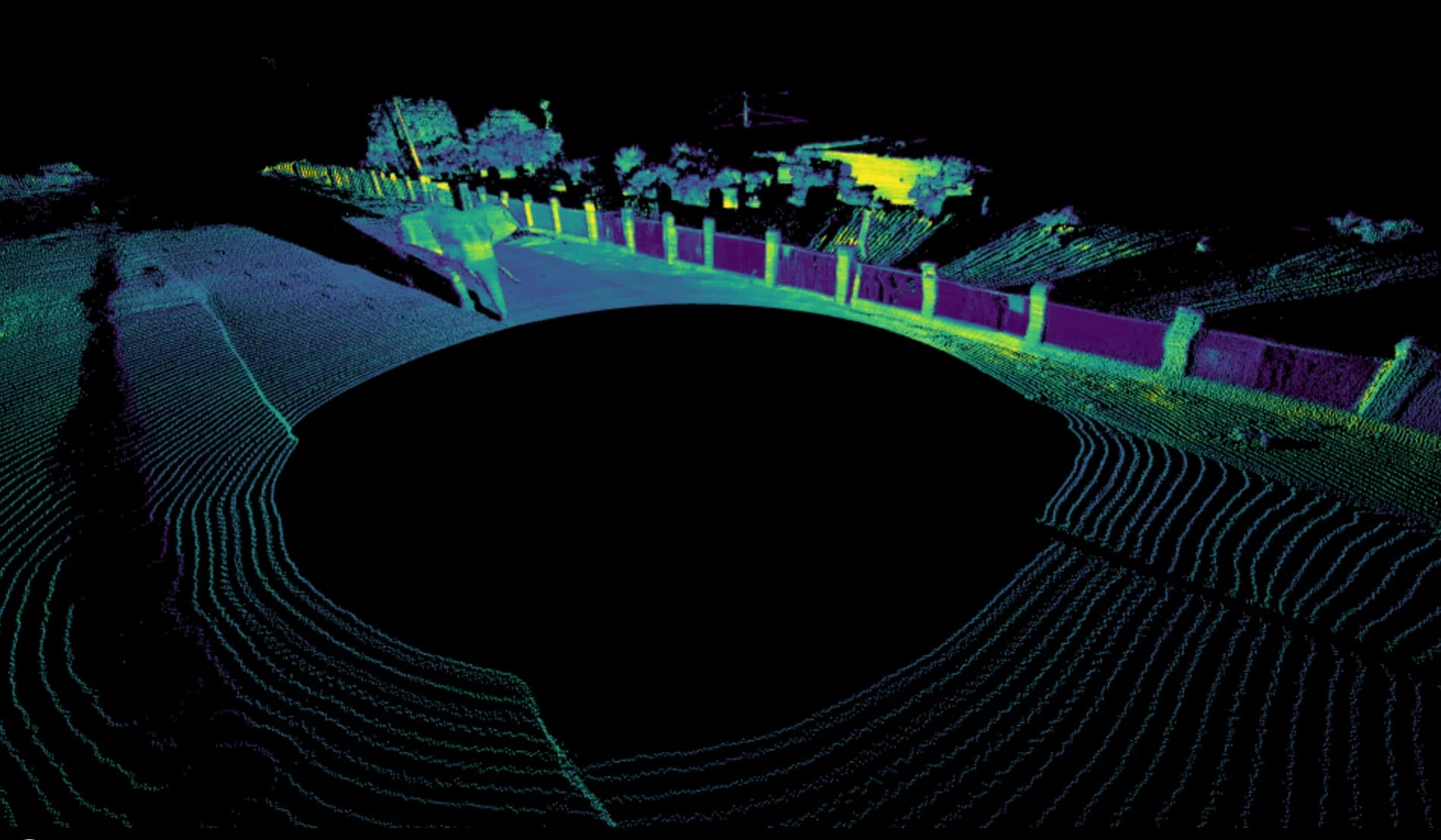 A high-fidelity 4D lidar point cloud visualization showing a top-down perspective of a simulated environment with an elephant standing near a roadside fence.